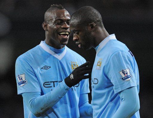 Mario Balotelli (left) speaks to Yaya Toure at the Etihad Stadium on February 25, 2012.