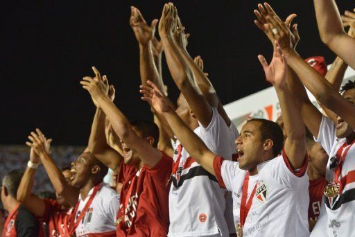 Sao Paulo players cheer as they are awarded victory in the Copa Sudamericana final in Sao Paulo on December 12, 2012