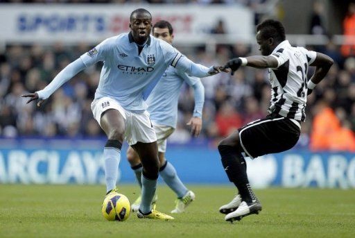 Newcastle United&#039;s Cheick Tiote (R) and Manchester City&#039;s Yaya Toure play in Newcastle, England on December 15, 2012