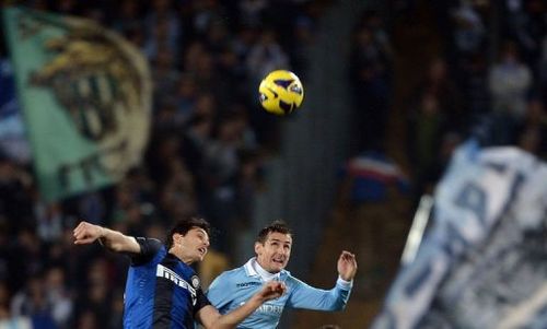 Lazio's forward Miroslav Klose (R) jumps for the ball with Inter Milan's defender Andrea Ranocchia on December 15, 2012