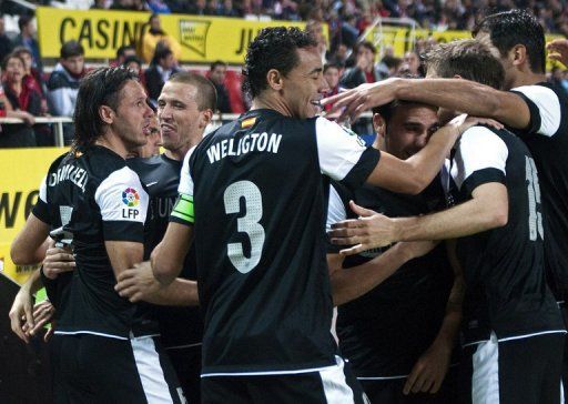 Malaga&#039;s Martin Demichelis (L) scoring a goal against Sevilla, on December 15, 2012