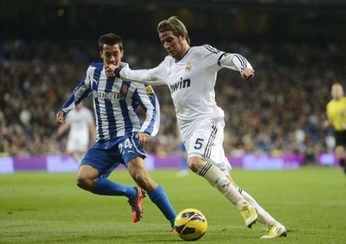 Real Madrid's Portuguese defender Fabio Coentrao (R) vies with Espanyol's midfielder Christian Alfonso