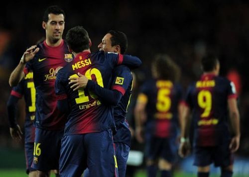 Barcelona's forward Lionel Messi (C) celebrates with midfielder Sergio Busquets (L) and defender Adriano (R)