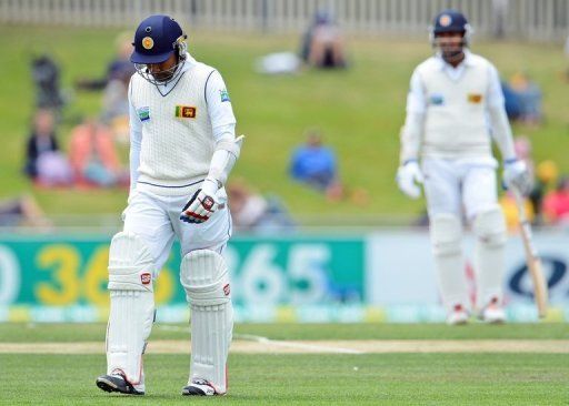 Mahela Jayawardene (L) walks off after being dismissed on the final day of the first Test in Hobart on December 18, 2012