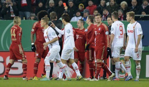 The referee shows the red card to Bayern Munich&#039;s Franck Ribery during a match against FC Augsburg on December 18, 2012