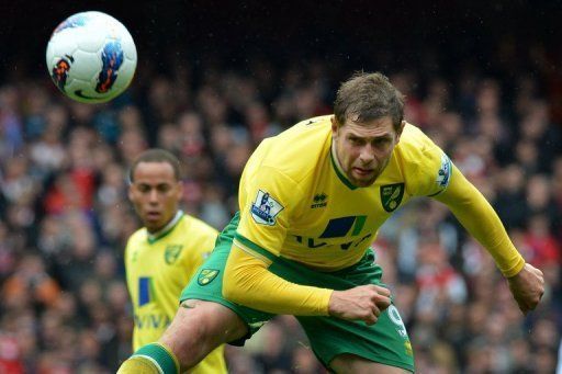 Grant Holt nods a header for Norwich against Arsenal at The Emirates Stadium in north London on May 5, 2012