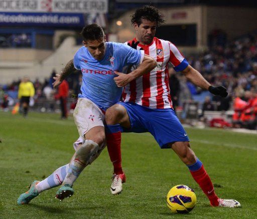 Atletico Madrid&#039;s forward Diego da Silva Costa (R) vies with Celta&#039;s defender Hugo Mallo (L) on December 21, 2012