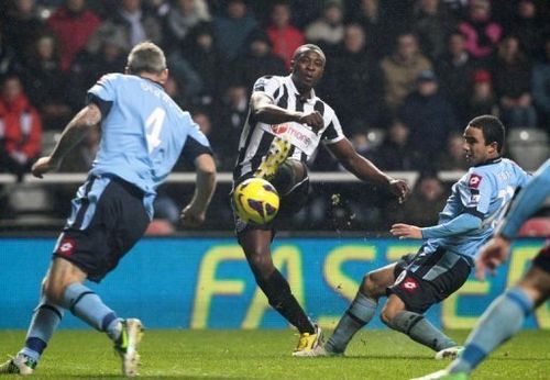 Newcastle's striker Shola Ameobi (2nd L) scores in Newcastle, England on December 22, 2012