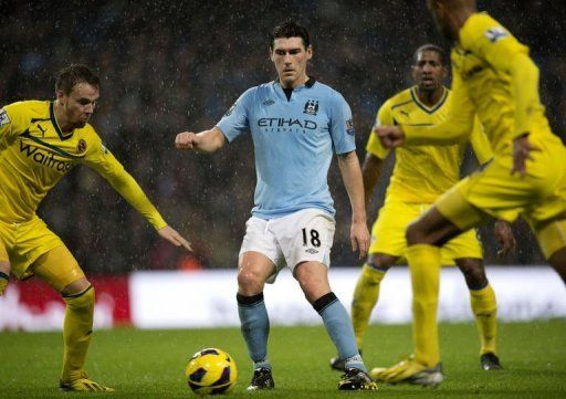 Manchester City&#039;s midfielder Gareth Barry fights for the ball in Manchester on December 22, 2012