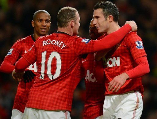 Man United&#039;s Wayne Rooney (C) and Robin van Persie (R)  at Old Trafford on December 15, 2012.