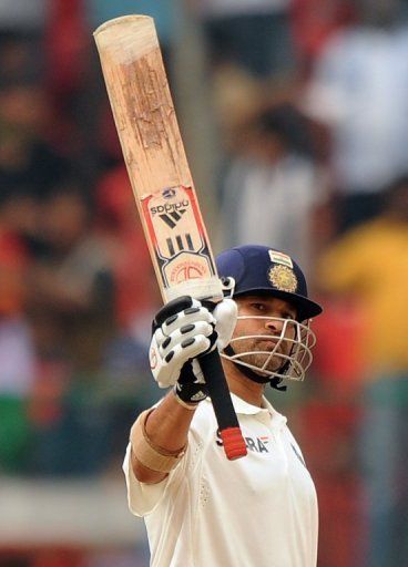 Sachin Tendulkar celebrates his half-century at M.Chinnaswamy Stadium in Bangalore on October 13, 2010