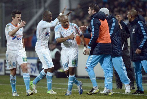 Marseille&#039;s Andre Ayew (C) is congratulated by his teammates after scoring on December 23, 2012