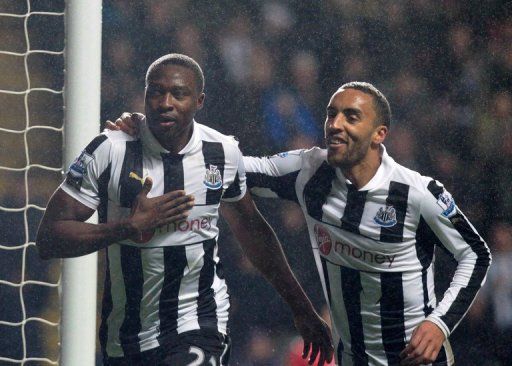 Shola Ameobi (L) celebrates scoring the winning goal for Newcastle against QPR on December 22, 2012