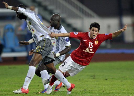 Guangzhou Evergrande&#039;s Dario Conca takes a tumble in an AFC Champions League clash on October 2, 2012