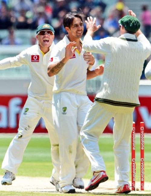 Australia's Mitchell Johnson (C) is congratulated by David Warner (L) and Michael Hussey, on December 28, 2012