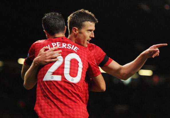 MANCHESTER, ENGLAND - SEPTEMBER 19:  Michael Carrick of Manchester United (R) celebrates with Robin van Persie (L) as he scores their first goal during the UEFA Champions League Group H match between Manchester United and Galatasaray at Old Trafford on September 19, 2012 in Manchester, England.  (Photo by Michael Regan/Getty Images)