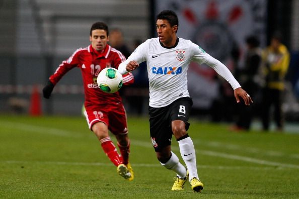 TOYOTA, JAPAN - DECEMBER 12:  Paulinho (R) of Corinthians challenges Ahmed Kenawi (L) of Al-Ahly SC during the FIFA Club World Cup Semi Final match between Al-Ahly SC and Corinthians at Toyota Stadium on December 12, 2012 in Toyota, Japan.  (Photo by Lintao Zhang/Getty Images)