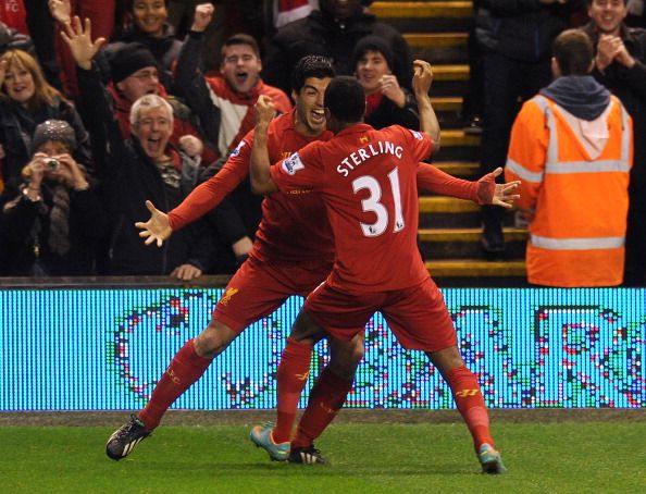 LIVERPOOL, ENGLAND - JANUARY 02:  (THE SUN OUT, THE SUN ON SUNDAY OUT) Raheem Sterling of Liverpool celebrates his goal with Luis Susrez to make it 1-0 during the Barclays Premier League match between Liverpool and Sunderland at Anfield on January 2, 2013 in Liverpool, England.  