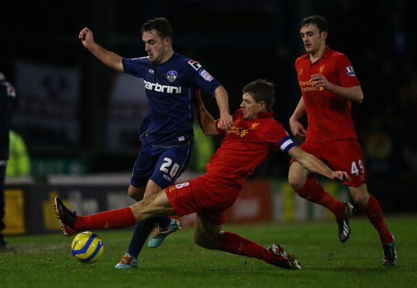 OLDHAM, ENGLAND - JANUARY 27:  Jose Baxter of Oldham competes with Steven Gerrard of Liverpool during the FA Cup with Budweiser Fourth Round match between Oldham Athletic and Liverpool at Boundary Park 