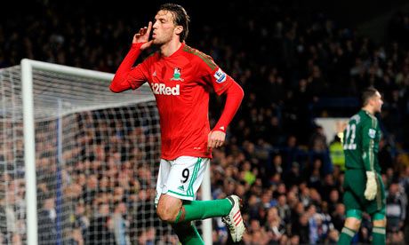 Michu celebrates scoring past Ross Turnbull to give Swnsea the lead at Stamford Bridge