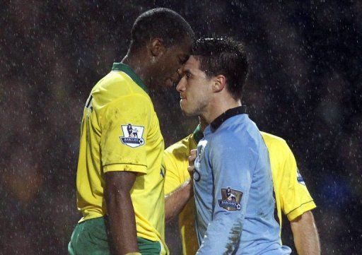 Manchester City&#039;s Samir Nasri (R) confronts Norwich City&#039;s Sebastien Bassong at Carrow Road, Norwich, December 29, 2012