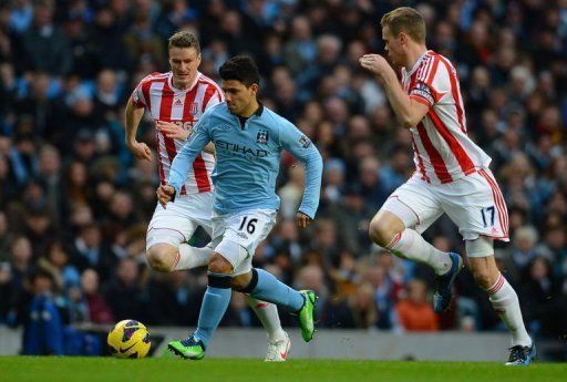 Sergio Aguero (C) gets away from Stoke defenders Robert Huth (L) and Ryan Shawcross on January 1, 2013
