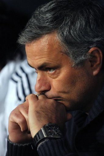 Real Madrid coach Jose Mourinho looks on before the Spanish league match against Malaga on December 22, 2012