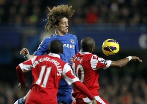 Chelsea defender David Luiz outjumps Stephane Mbia (R) and Shaun Wright-Phillips at Stamford Bridge on January 2, 2013