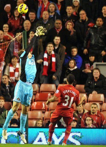 Liverpool&#039;s Raheem Sterling (R) scores over Sunderland&#039;s Simon Mignolet (L) at Anfield on January 2, 2013