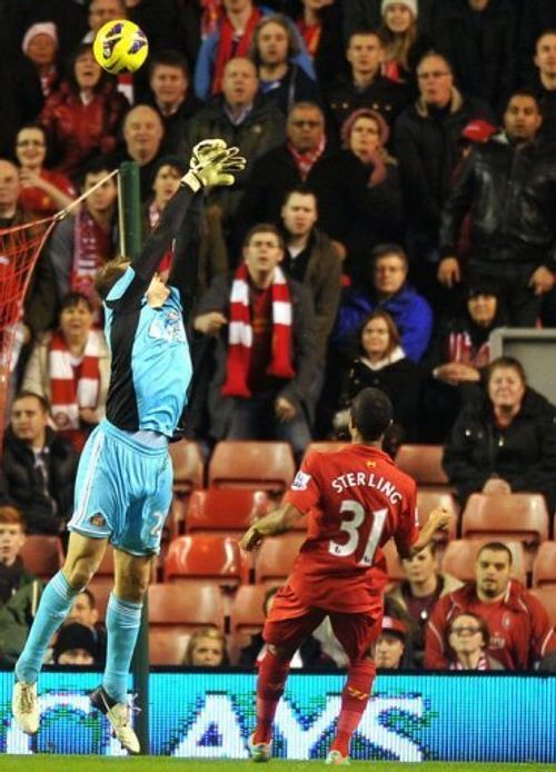 Liverpool's Raheem Sterling (R) scores over Sunderland's Simon Mignolet (L) at Anfield on January 2, 2013