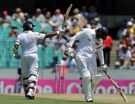 Mahela Jayawardene raises his bat after reaching 50 on day one of the third Test against Australia on January 3, 2013