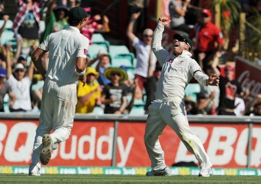 David Warner (R) reacts after taking a catch to dismiss Lahiru Thirimanne on day one of the third Test on January 3, 2013