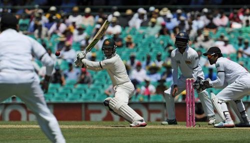 Australia's Phil Hughes (C) plays a cut shot during Test against Sri Lanka, in Sydney, on January 4, 2013.