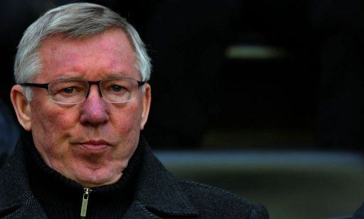 Alex Ferguson watches a match in Wigan on January 1, 2013