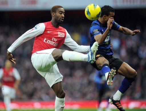 Arsenal&#039;s Johan Djourou (left) and Manchester United&#039;s Patrice Evra , January 22, 2012 at the Emirates Stadium in London