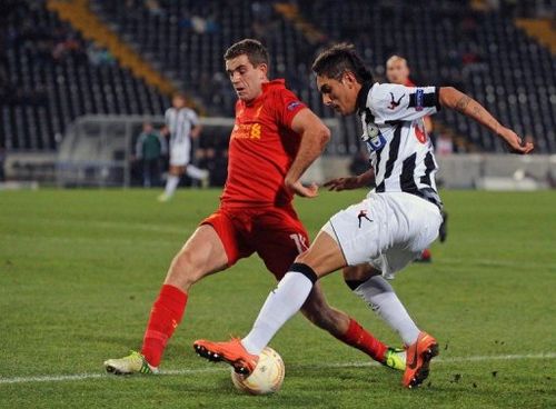 Jordan Henderson (L) loses the ball to Udinese's Roberto Maximilliano in the Europa League on December 6, 2012