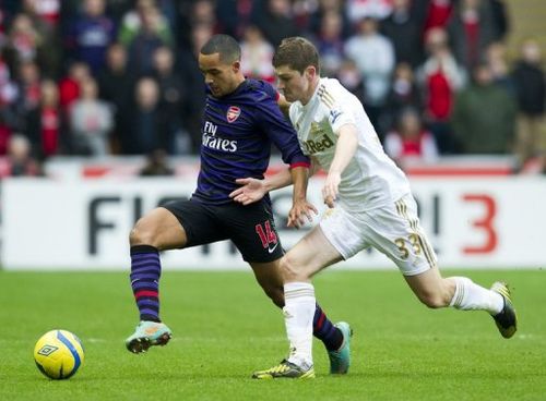 Arsenal's Theo Walcott (left) and Swansea City's Ben Davies at The Liberty Stadium in Swansea, Wales on January 6, 2013