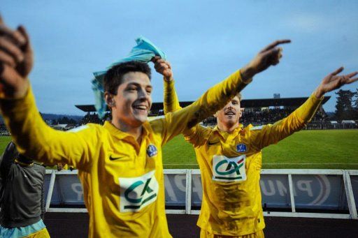 Epinal&#039;s players celebrate after beating Lyon at the Colombiere Stadium in Epinal, on January 6, 2013