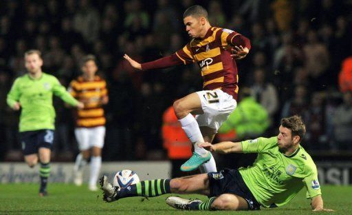 Bradford forward Nahki Wells evades the challenge of Nathan Baker in their League Cup semi-final clash on January 8, 2013