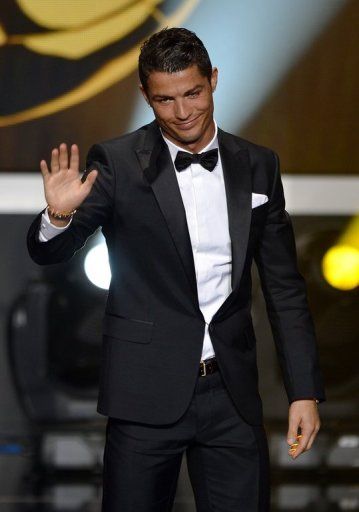 Cristiano Ronaldo waves on stage during the FIFA Ballon d&#039;Or awards ceremony in Zurich on January 7, 2013