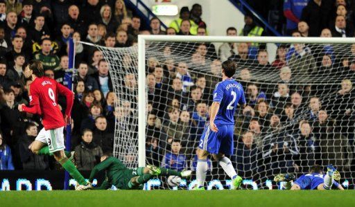 Michu (L) wheels away after putting Swansea ahead at Chelsea in their League Cup semi-final clash on January 9, 2013