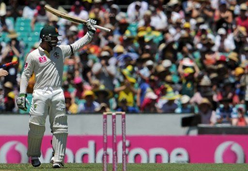 Phil Hughes raises his bat after reaching 50 on day two of the third Test against Sri Lanka on January 4, 2013