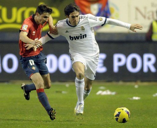 Real Madrid&#039;s Masoud Shojaei (R) clashes with Osasuna&#039;s Oier Sanjurjo in Pamplona, January 12, 2013