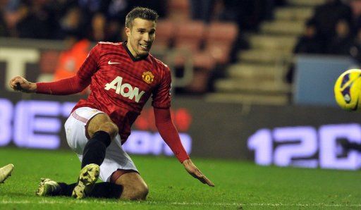 Manchester United&#039;s Robin Van Persie scores a goal against Wigan, at The DW Stadium in Wigan, on January 1, 2013