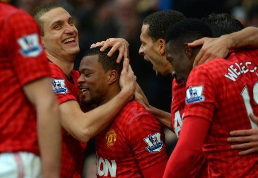 United&#039;s Nemanja Vidic (L) and Patrice Evra (C) celebrate at Old Trafford on January 13, 2013