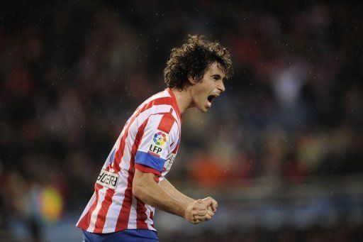 Atletico Madrid&#039;s Tiago Cardoso Mendes celebrates after scoring at the Vicente Calderon stadium on January 13, 2012