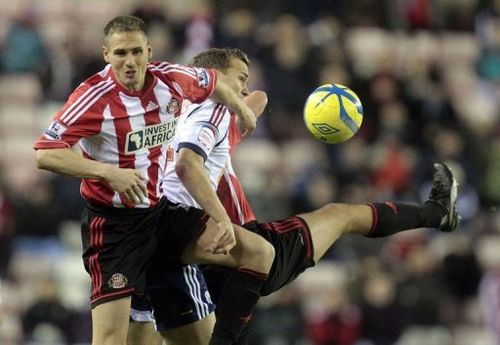 Sunderland defender Matt Kilgallon (L) battles with Bolton striker Kevin Davies on January 15, 2013