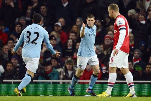 Manchester City midfielder James Milner (C) celebrates the opening goal at Arsenal on January 13, 2013
