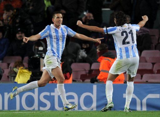 Malaga&#039;s Ignacio Camacho (L) celebrates with Sergio Sanchez at the Camp Nou stadium in Barcelona on January 16, 2013