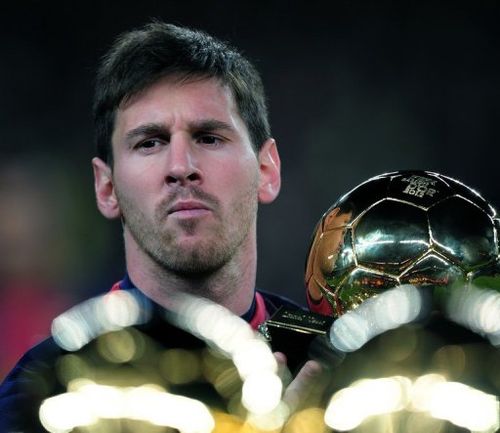 Barcelona's Lionel Messi holds his 4th FIFA Ballon d'Or trophy prior to the match in Barcelona on January 16, 2013